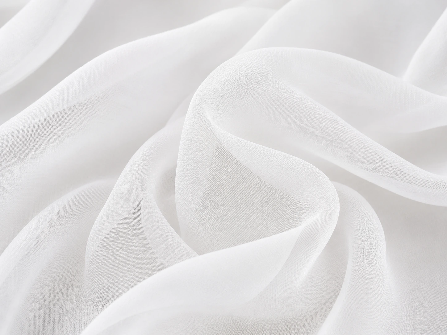 White silk chiffon fabric closeup with airy folds and sheer texture