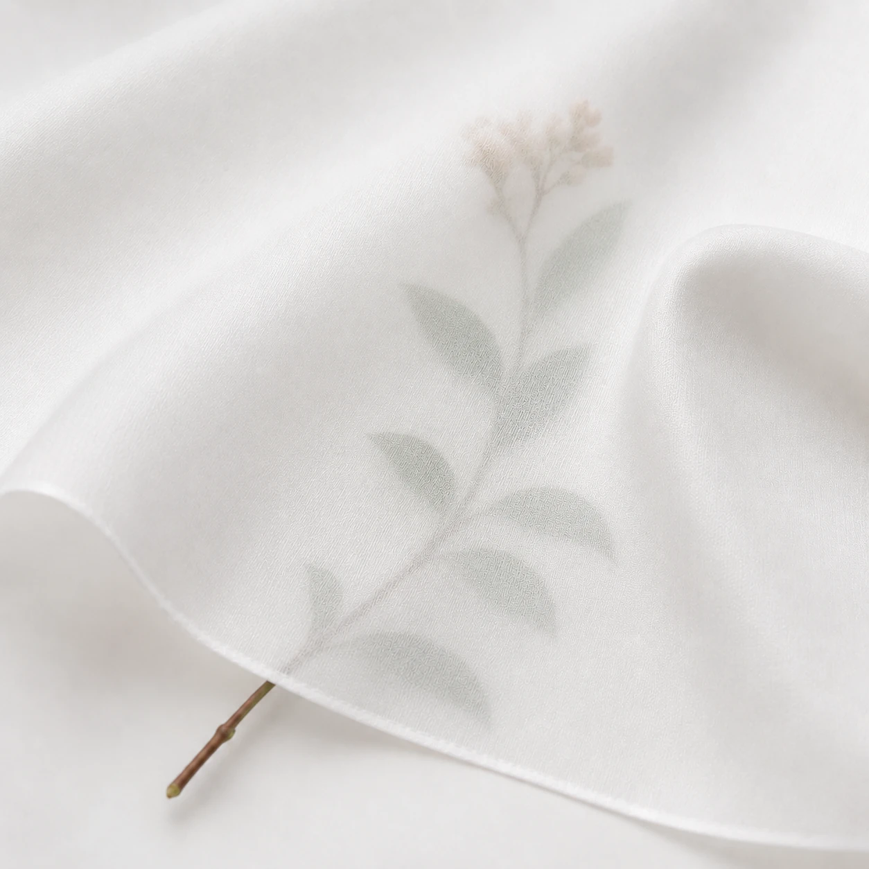 White silk twill fabric with soft drape, elegant folds, and smooth refined texture.