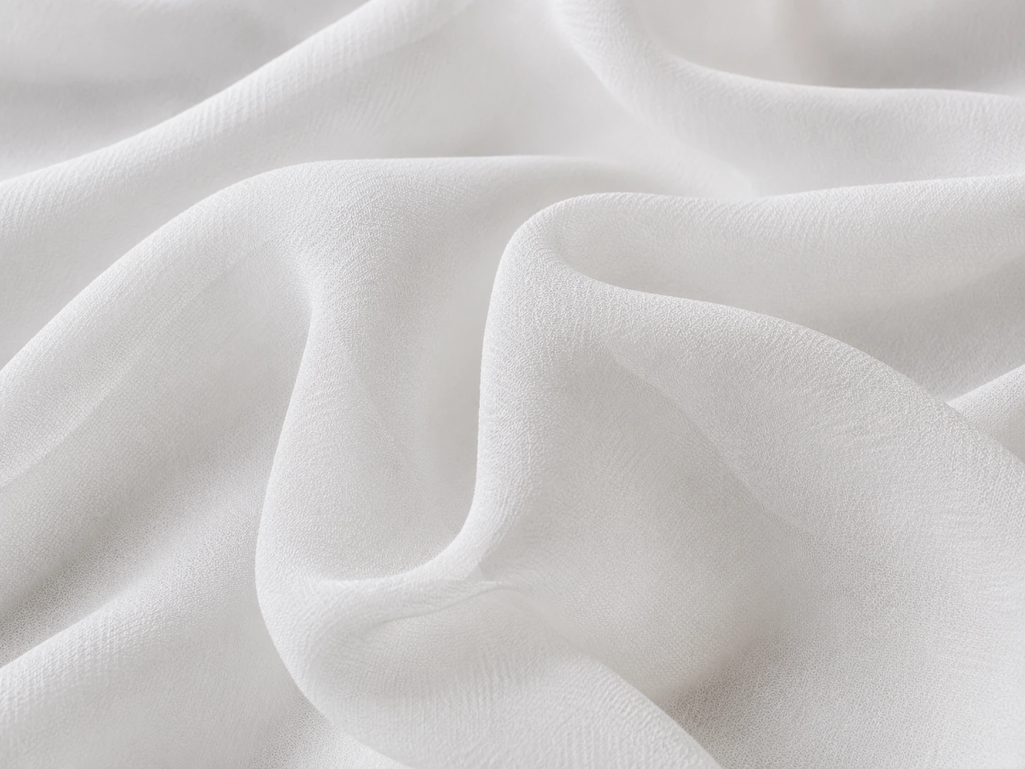 White silk habotai fabric closeup with smooth surface and soft folds