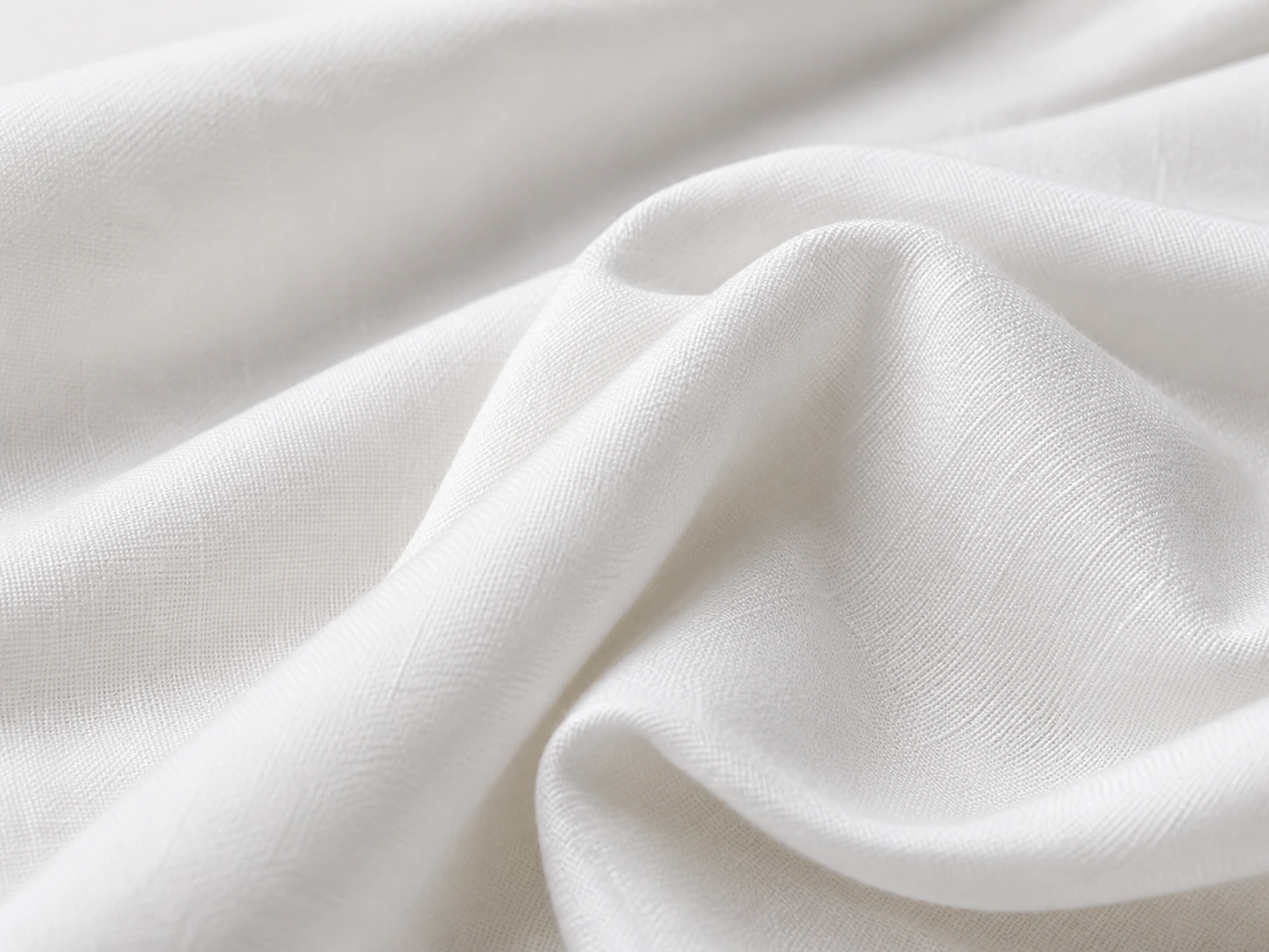 White silk cotton fabric closeup with soft texture and natural folds