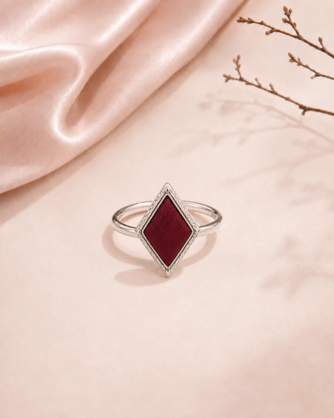 Diamond-shaped ring with solid burgundy silk center and decorative silver-tone metal frame
