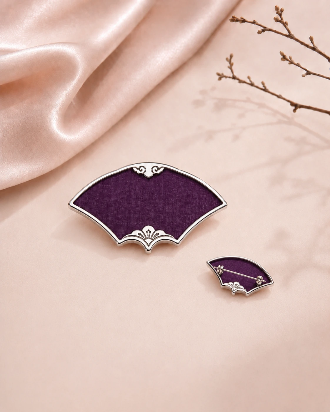 Fan-shaped purple silk brooch shown from the front and back with visible metal pin fastening