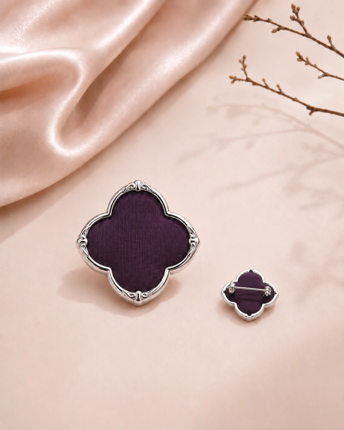 Flower-shaped purple silk brooch with decorative front and smaller back view showing pin
