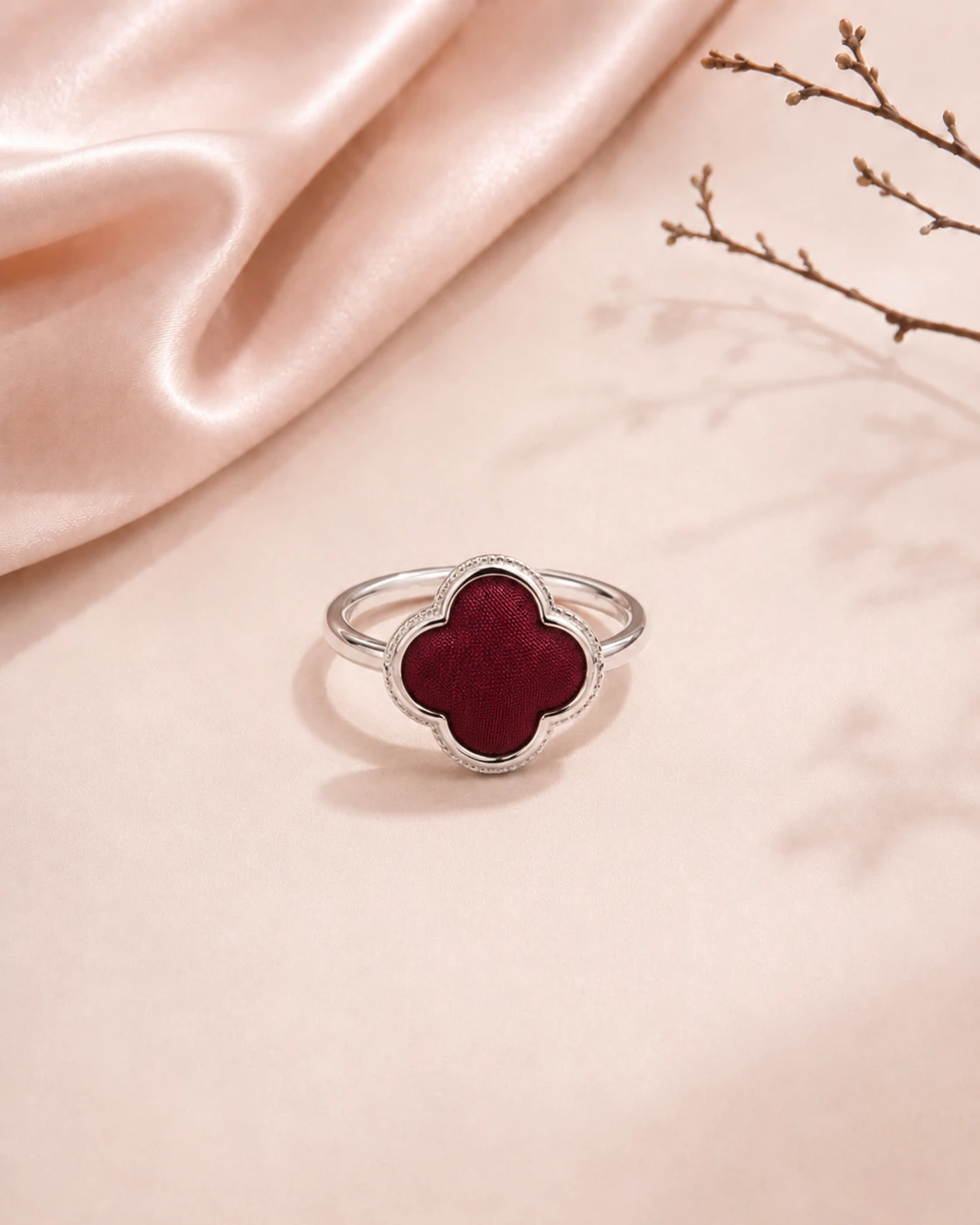 Petal-shaped ring with solid burgundy silk center and polished silver-tone border