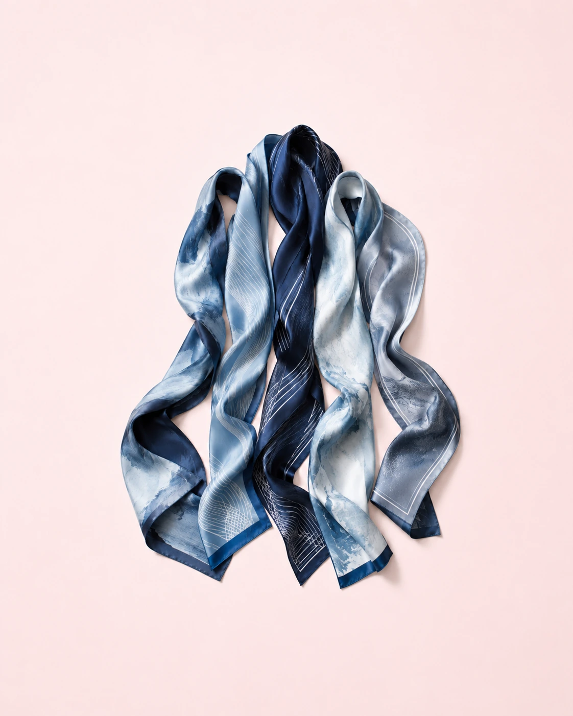 Elegant blue silk scarves with abstract wave and gradient digital print, premium luxury fabric design on soft blush background