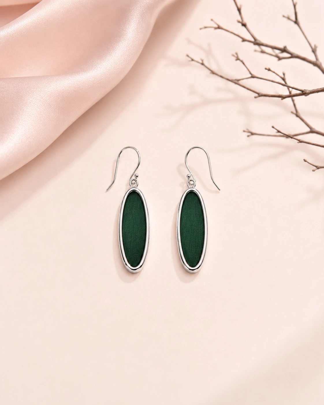 Slim oval drop earrings with solid dark green silk and silver-tone metal borders